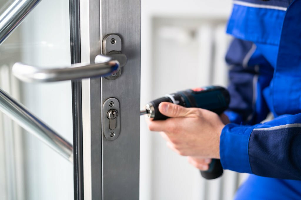 Locksmith Man Repairing And Changing Metal Door Lock