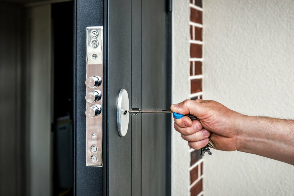 Human hand puts the key in the keyhole of entrance door