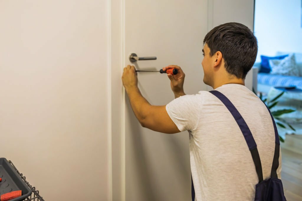 Door lock service - locksmith working in Blue uniform