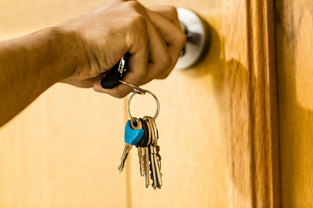 Man opening his home door with key