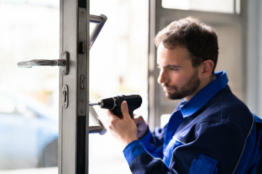 Locksmith Man Repairing And Changing Metal Door Lock