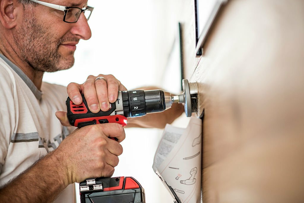 Closeup photo of a handyman using a drilling machine