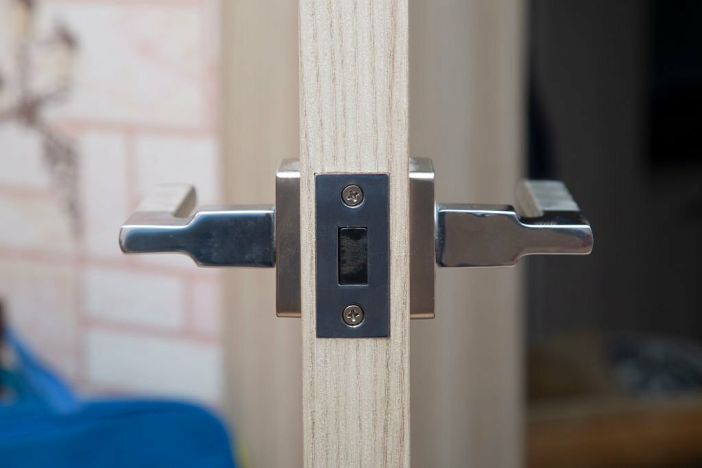 Locks and handles on doors.Installation of locks on interior doors.